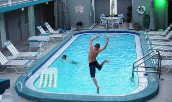 Camelot Beach Suites kid jumping in pool